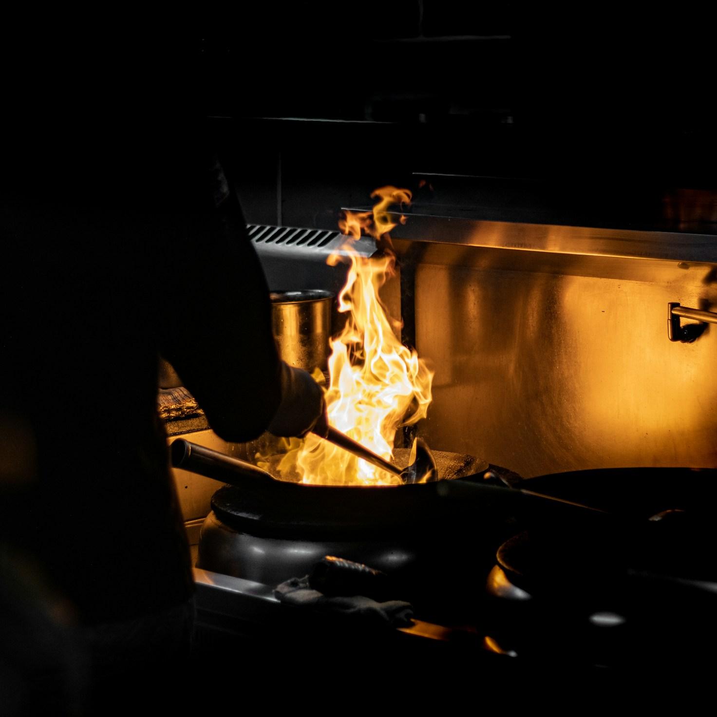 Community members collaborating in a modern kitchen, exchanging recipes and cooking skills
